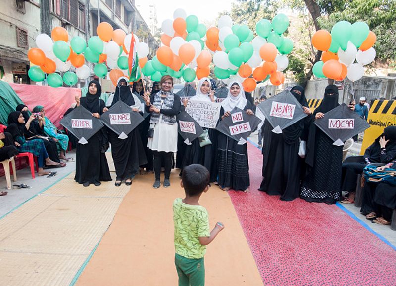 women in front of against national citizenship amendment bill photo story