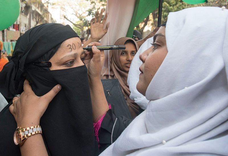 women in front of against national citizenship amendment bill photo story
