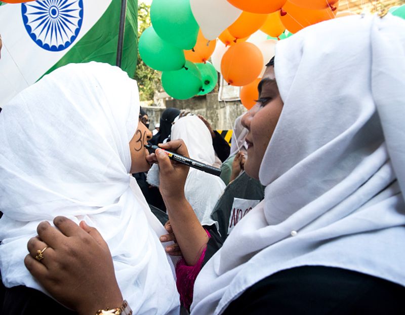 women in front of against national citizenship amendment bill photo story