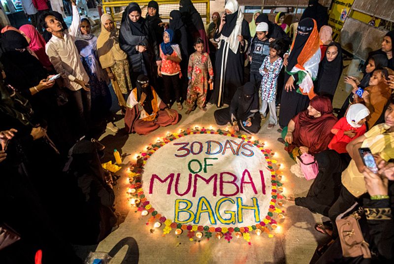 women in front of against national citizenship amendment bill photo story