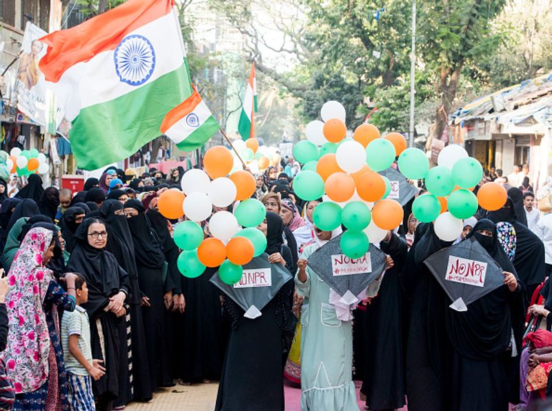 women in front of against national citizenship amendment bill photo story
