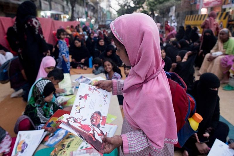 women in front of against national citizenship amendment bill photo story