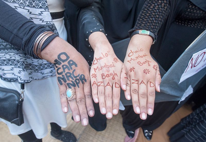 women in front of against national citizenship amendment bill photo story