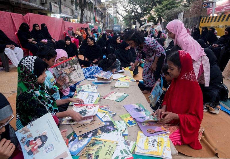 women in front of against national citizenship amendment bill photo story