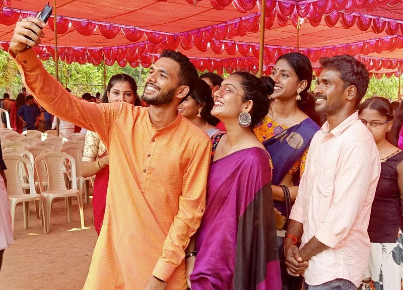 Photo gallery of Kambala buffalo jockey Srinivas Gowda poses to selfie with students