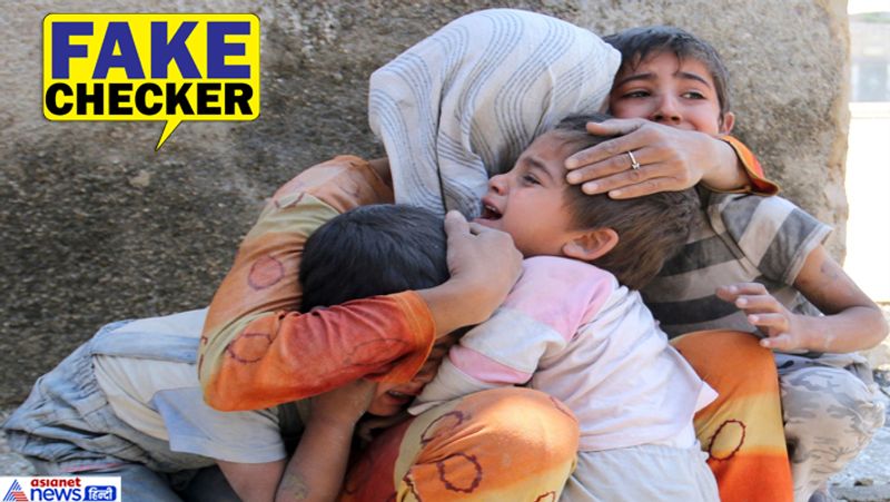 women sitting outside of burning house with children crying photo from syria shared as delhi riots kpt