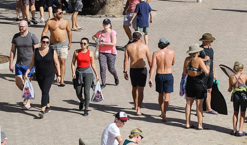 crowd gathered on australian roads and beaches to enjoy during corona outbreak can help spread virus rapidly kph