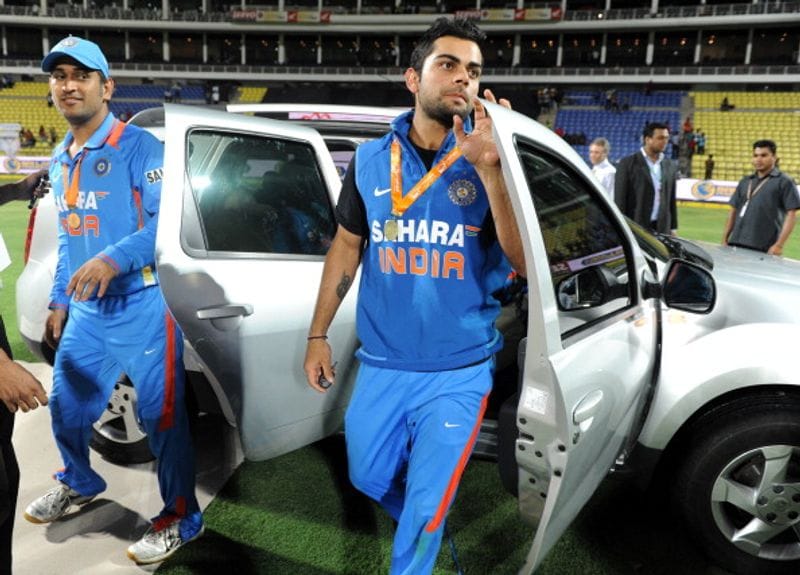 Mahendra Singh Dhoni (left) and Kohli exit the Renault Duster SUV after their victory in the fifth and final one-day international (ODI) match between Sri Lanka and India at the Pallekele International Cricket Stadium in Pallekele on August 4, 2012. Kohli won Duster as Man-of-the-series award.