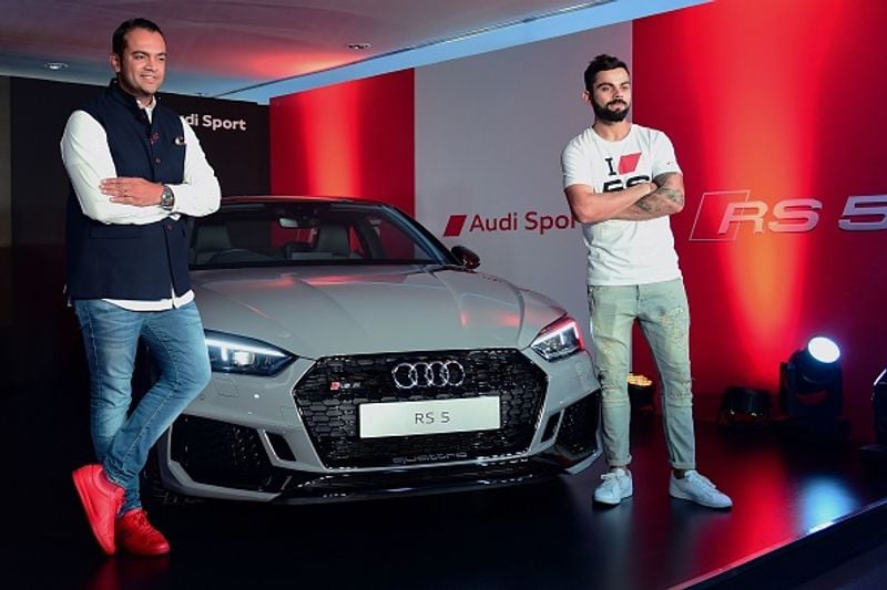 Kohli poses for a picture during a launch event for the Audi R5 coupe car, in Bangalore on April 11, 2018.