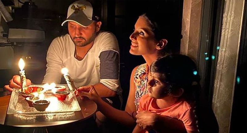 क्रिकेटर हरभजन सिंह ने पत्नी गीता बरसा और बेटी के साथ मिलकर दीया जलाया।