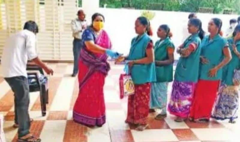 dmk women cadre gives grocery products to people involving in corona prevention activities