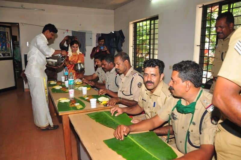 Newly wedded couple serving food to police officers