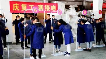 While world suffers from coronavirus spread, China organises kissing competition as part of factory reopening