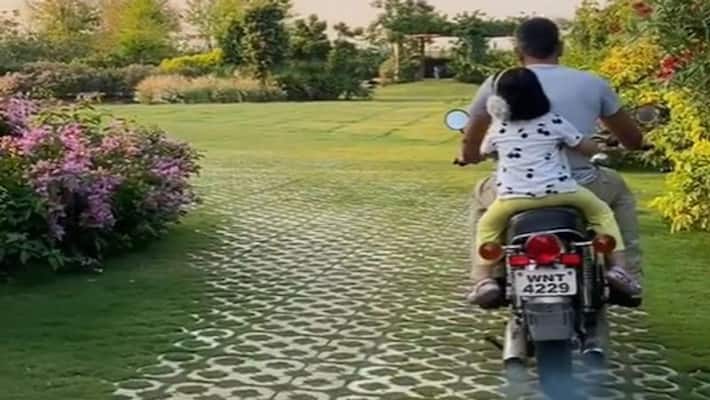 dhoni riding on bike at farmhouse with his daughter kpl dhoni riding on bike at farmhouse with his daughter kpl