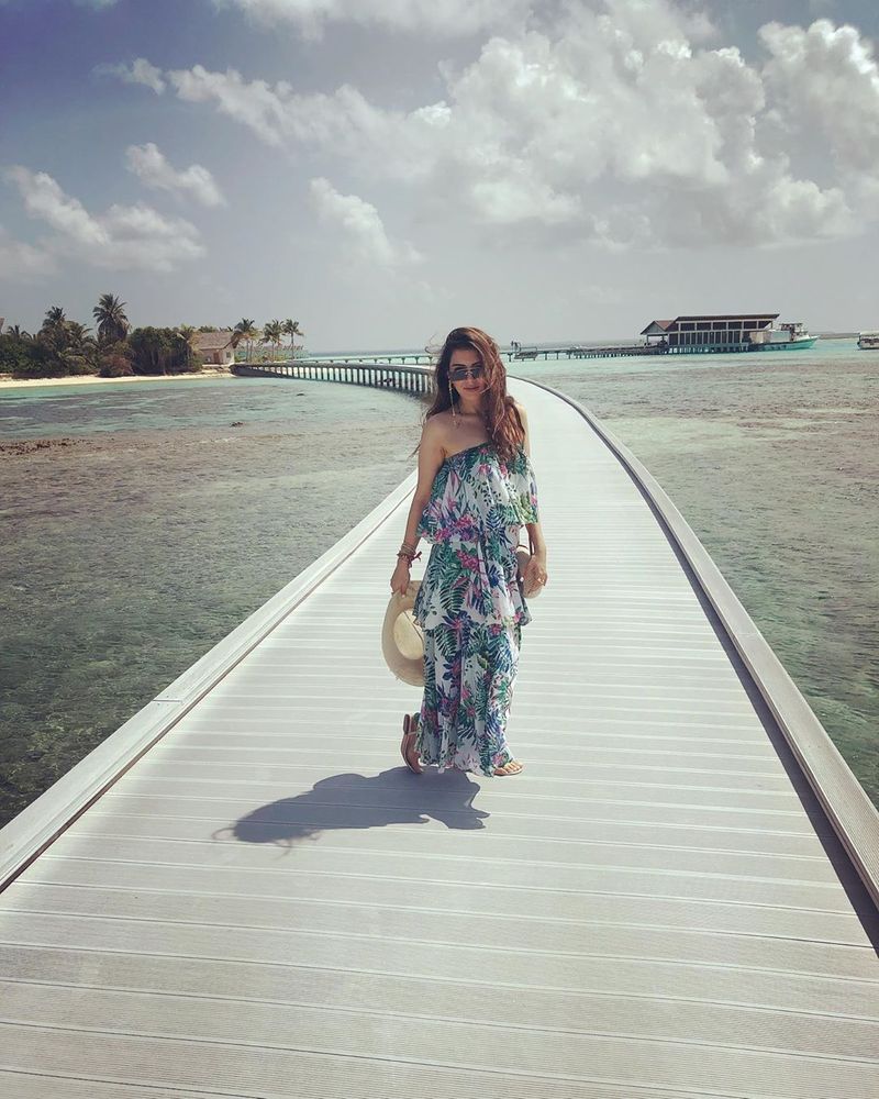 The actress was in Maldives for a holiday as the lockdown began. Being a social butterfly, she has been updating fans about her stay through the social media. The latest update is one that is too hot to handle as she posed in a bikini holding a glass of wine, sitting by the beach side.
