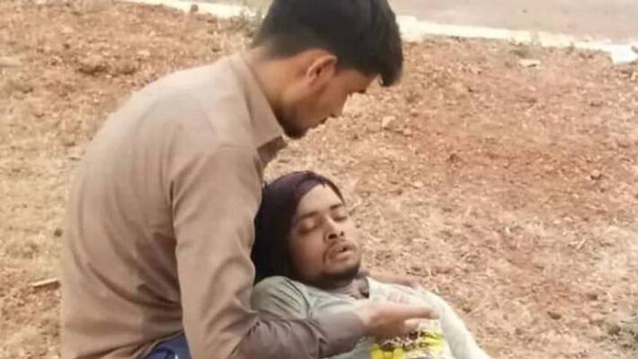 Migrant Lies On Friend's Lap died at a hospital Migrant Lies On Friend's Lap died at a hospital