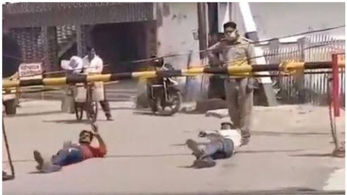 two police men suspended for making labourers rolling on the road in uttar pradesh two police men suspended for making labourers rolling on the road in uttar pradesh
