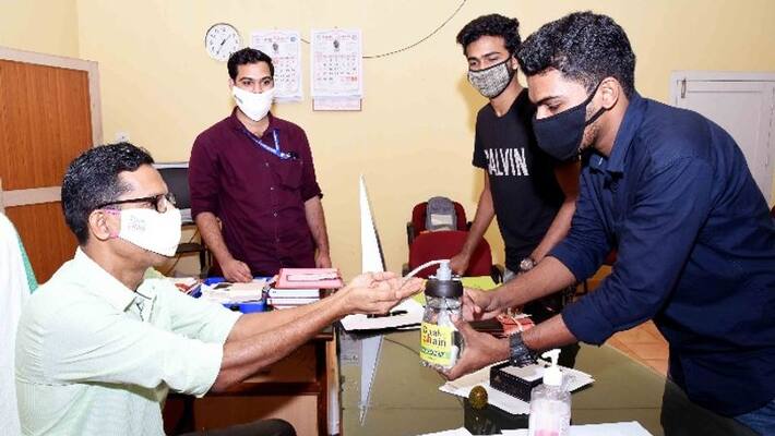 Engineering student with automatic sanitizer sprayer Engineering student with automatic sanitizer sprayer