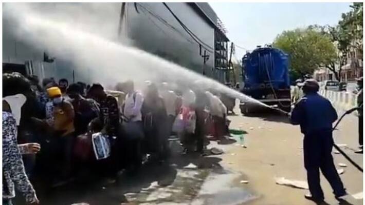 civic agency sprayed with a disinfectant on group of migrants in delhi civic agency sprayed with a disinfectant on group of migrants in delhi