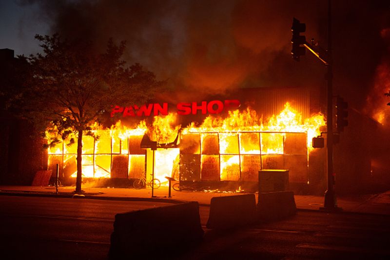 A pawn shop down the street from the 3rd precinct burns to the ground on Thursday, May 28 in Minneapolis.