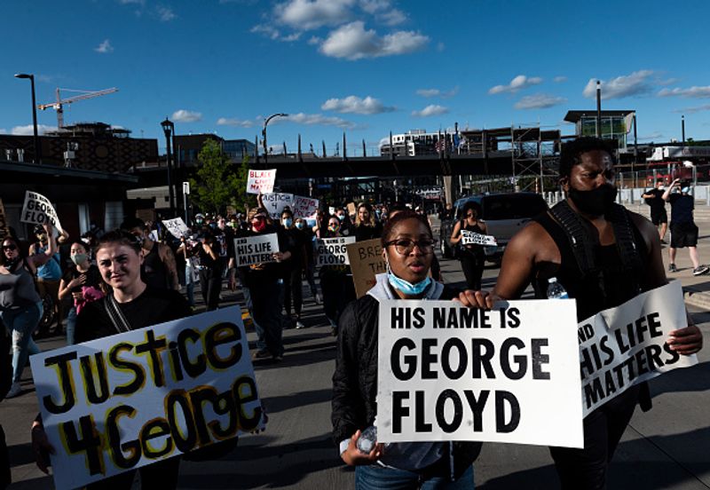 Protesters march by US Bank Stadium on May 29 in Minneapolis, Minnesota.