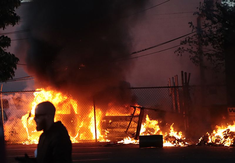 Vehicles burn during a protest on May 29, in Minneapolis, Minnesota.