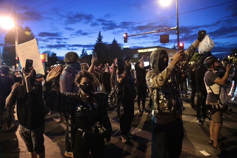 People hold their hands up during a protest on May 29 in Minneapolis, Minnesota.