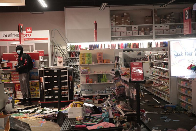 A man stands inside a ransacked store on May 29, in Minneapolis, Minnesota.
