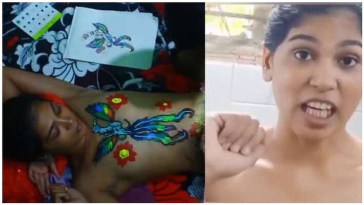 Rehana painting her children in half relief body Rehana painting her children in half relief body