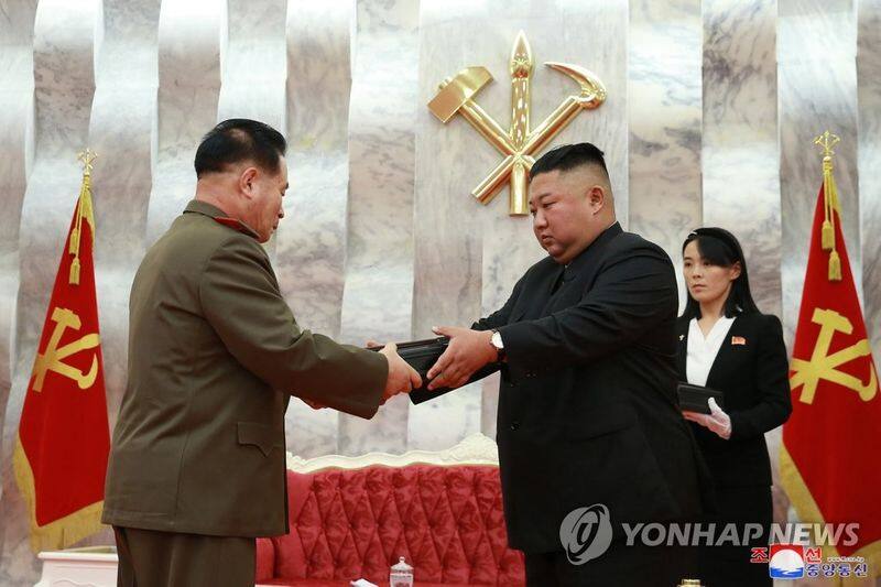kim jong un gifts his generals with special hand guns to celebrate war anniversary
