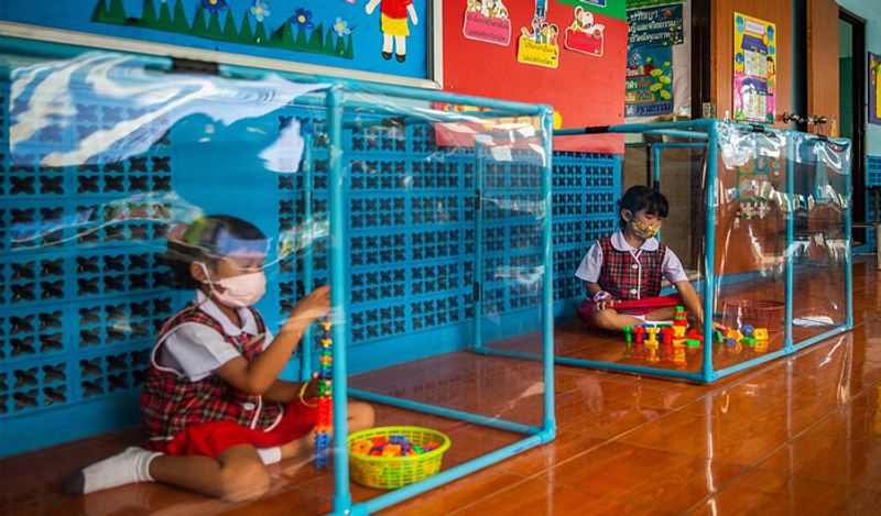 Schools opened in thailand between Corona with most strictest social distancing rules children locked in cages and taking classes like this kph