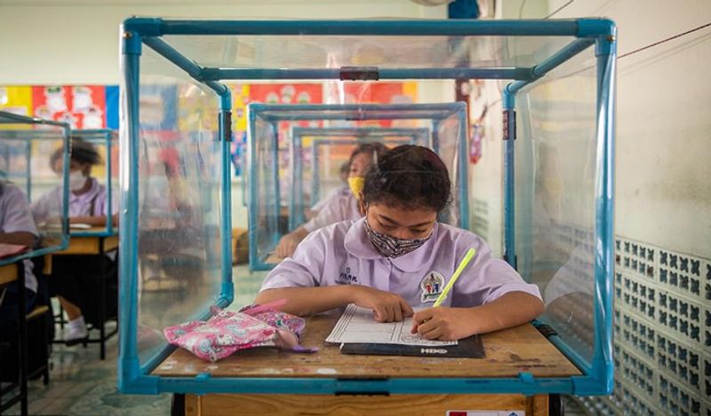 Schools opened in thailand between Corona with most strictest social distancing rules children locked in cages and taking classes like this kph