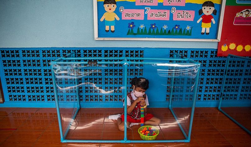 Schools opened in thailand between Corona with most strictest social distancing rules children locked in cages and taking classes like this kph