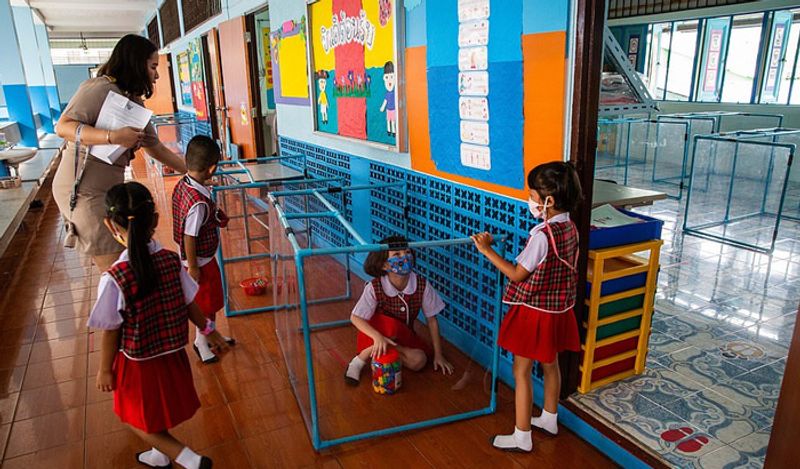 Schools opened in thailand between Corona with most strictest social distancing rules children locked in cages and taking classes like this kph