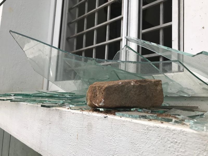 Huge stone and broken window panes show the pieces that others are left to pick up after the destruction caused by certain people in DJ Halli and KG Halli