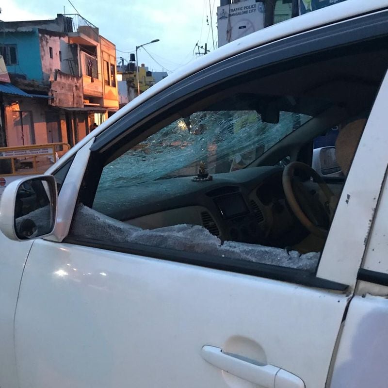DCP East Sharanappa's damaged car bears a shattered windshield
