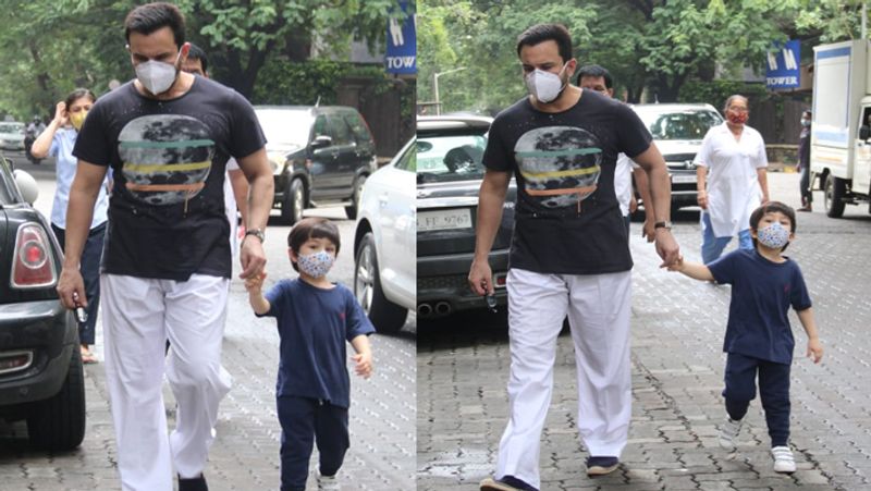 Taimur ali khan walking on road holding papa saif ali khan hands but he was looking somewhere else KPJ