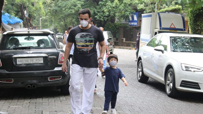Taimur ali khan walking on road holding papa saif ali khan hands but he was looking somewhere else KPJ