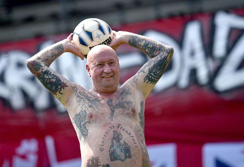 nude players play football in protest against corporate