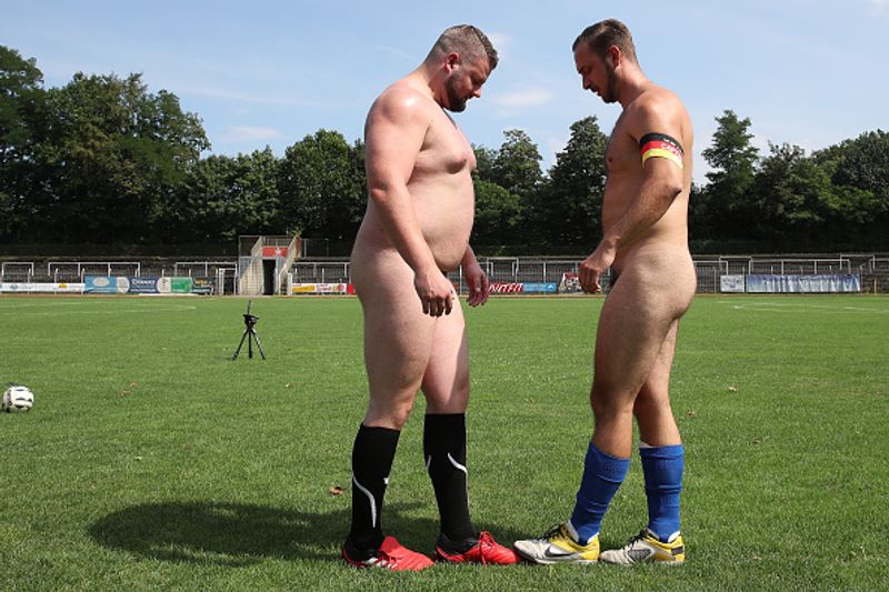 nude players play football in protest against corporate