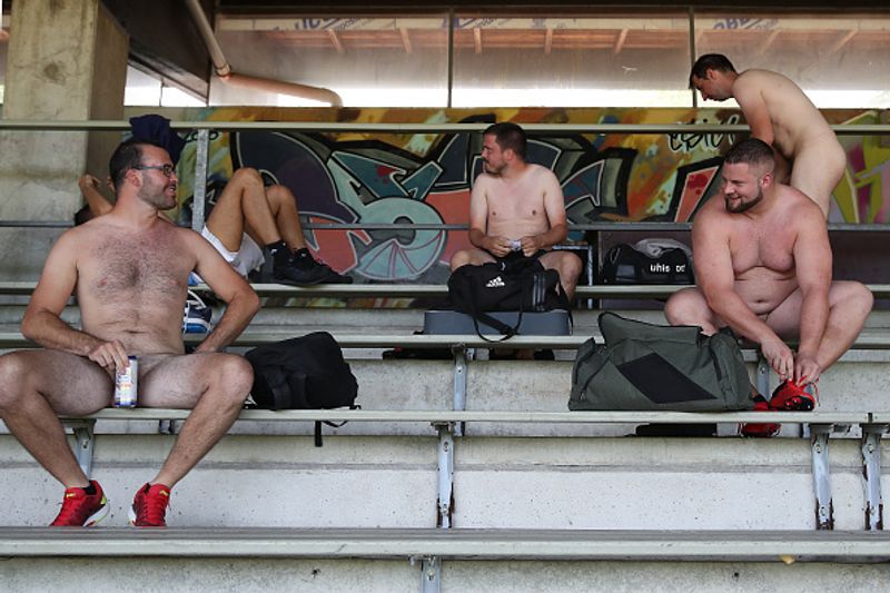 nude players play football in protest against corporate