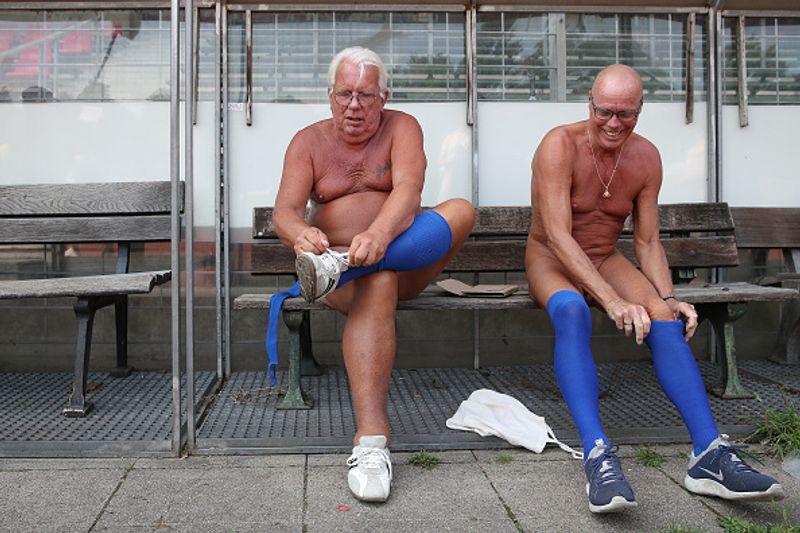 nude players play football in protest against corporate