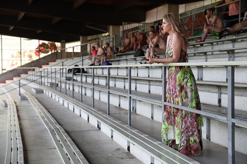 nude players play football in protest against corporate