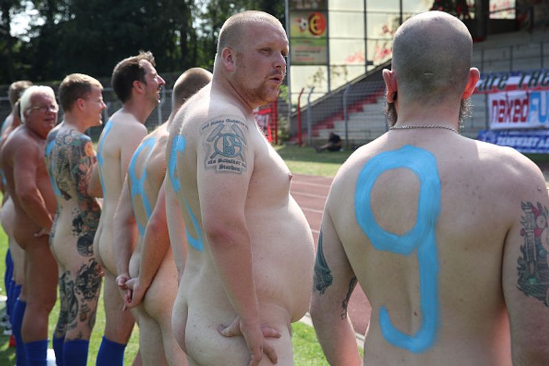 nude players play football in protest against corporate