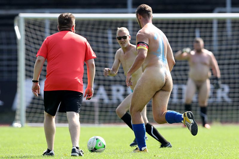 nude players play football in protest against corporate