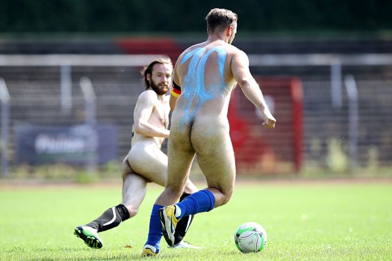 nude players play football in protest against corporate