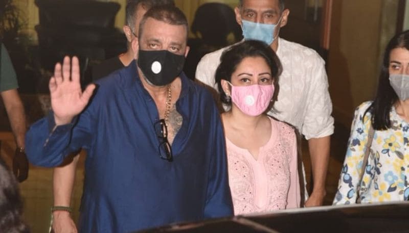 Actor Sanjay Dutt shows a thumbs-up sign as he leaves from his residence for Kokilaben hospital in Mumbai