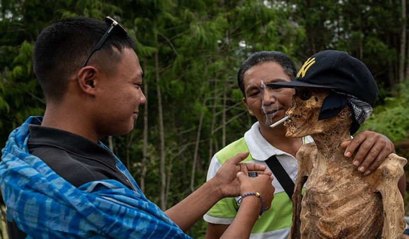 Indonesia Toraja Death Ritual where families dig dead relatives every year in august kph