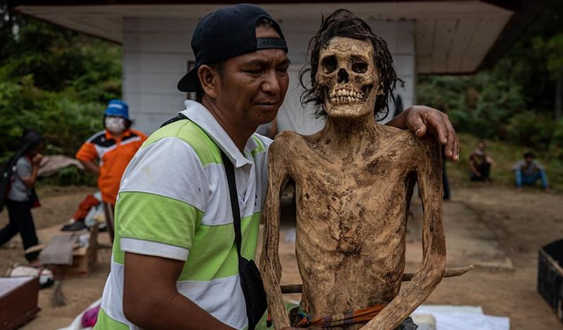 Indonesia Toraja Death Ritual where families dig dead relatives every year in august kph