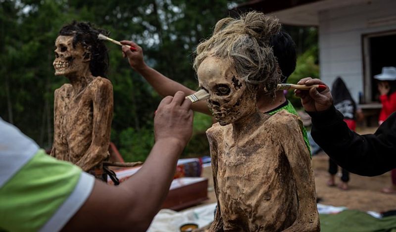 Indonesia Toraja Death Ritual where families dig dead relatives every year in august kph